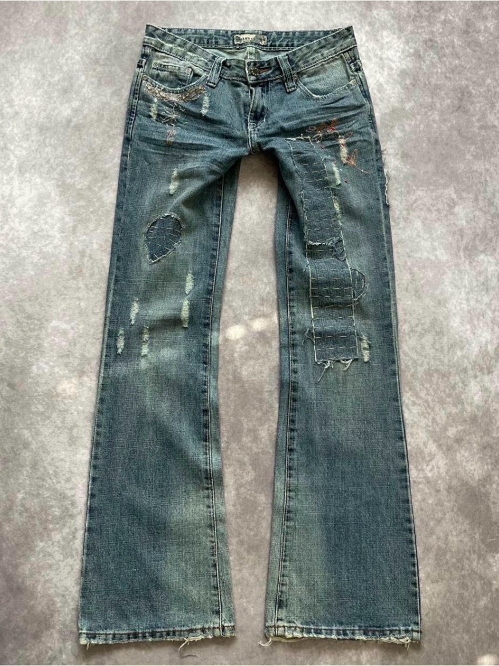 Perfect condition. Never worn distressed jeans with rhinestones and gems.